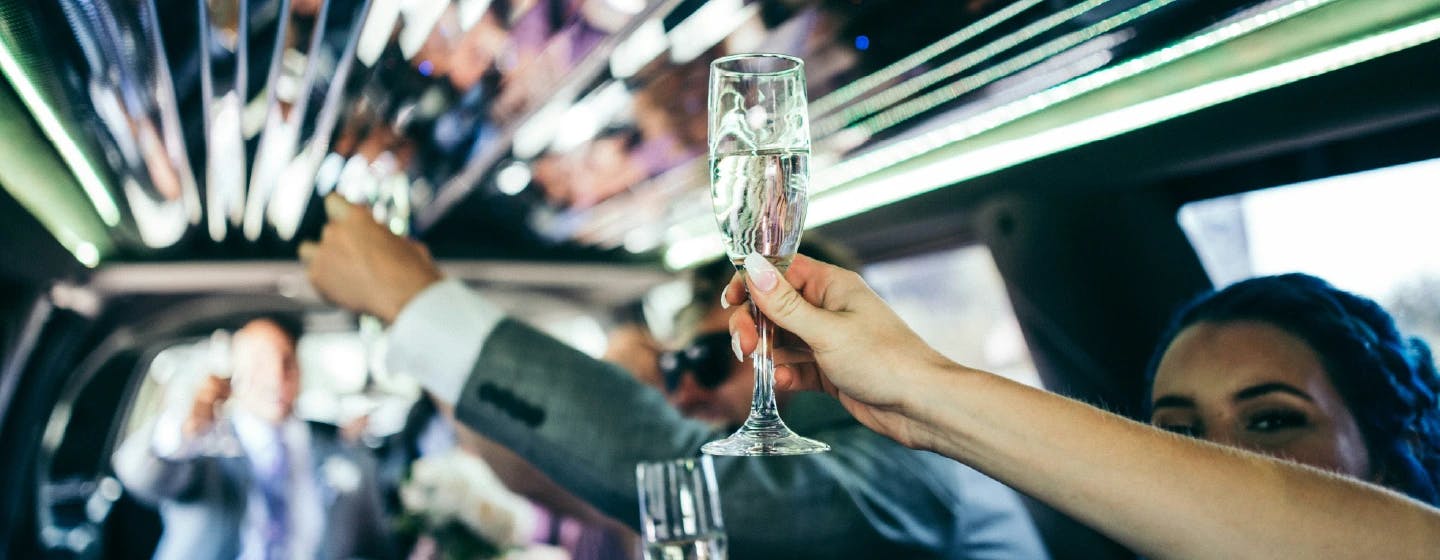 people toasting champagne in the back of a party bus, representing firefish award win with paypal for best client agency collaboration